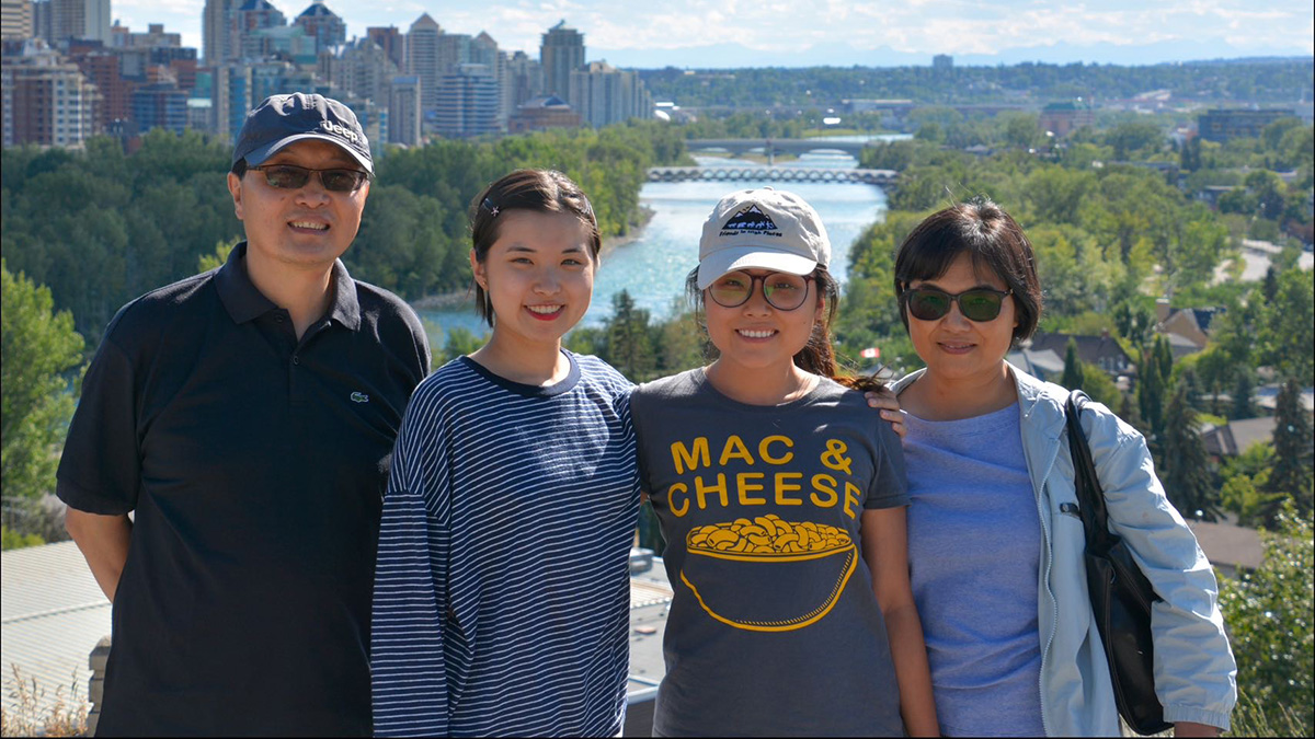 Yang with her parents and younger sister in Calgary.