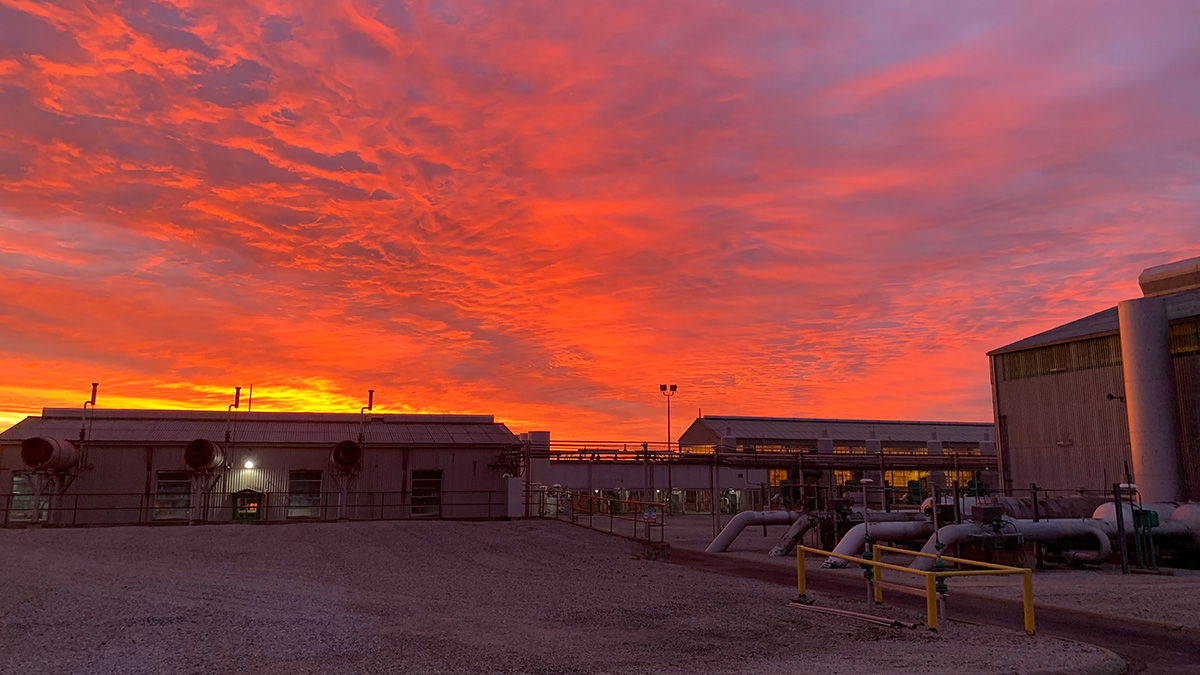A natural gas facility with a colorful sky