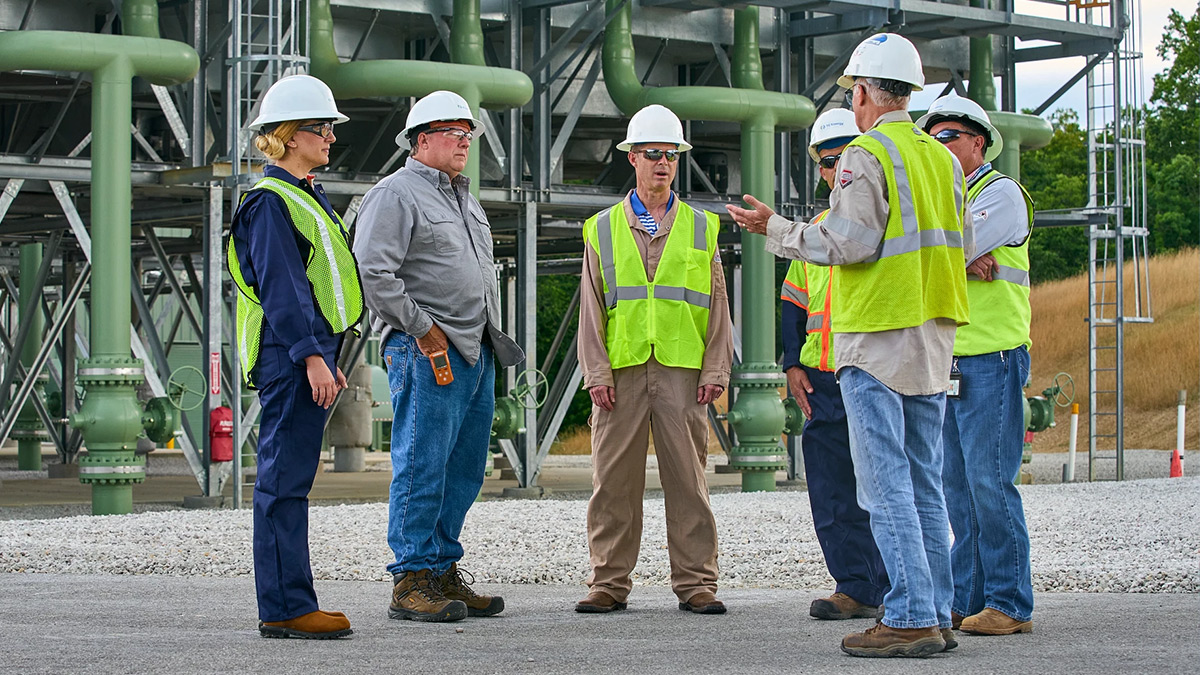 Workers standing around discussing something