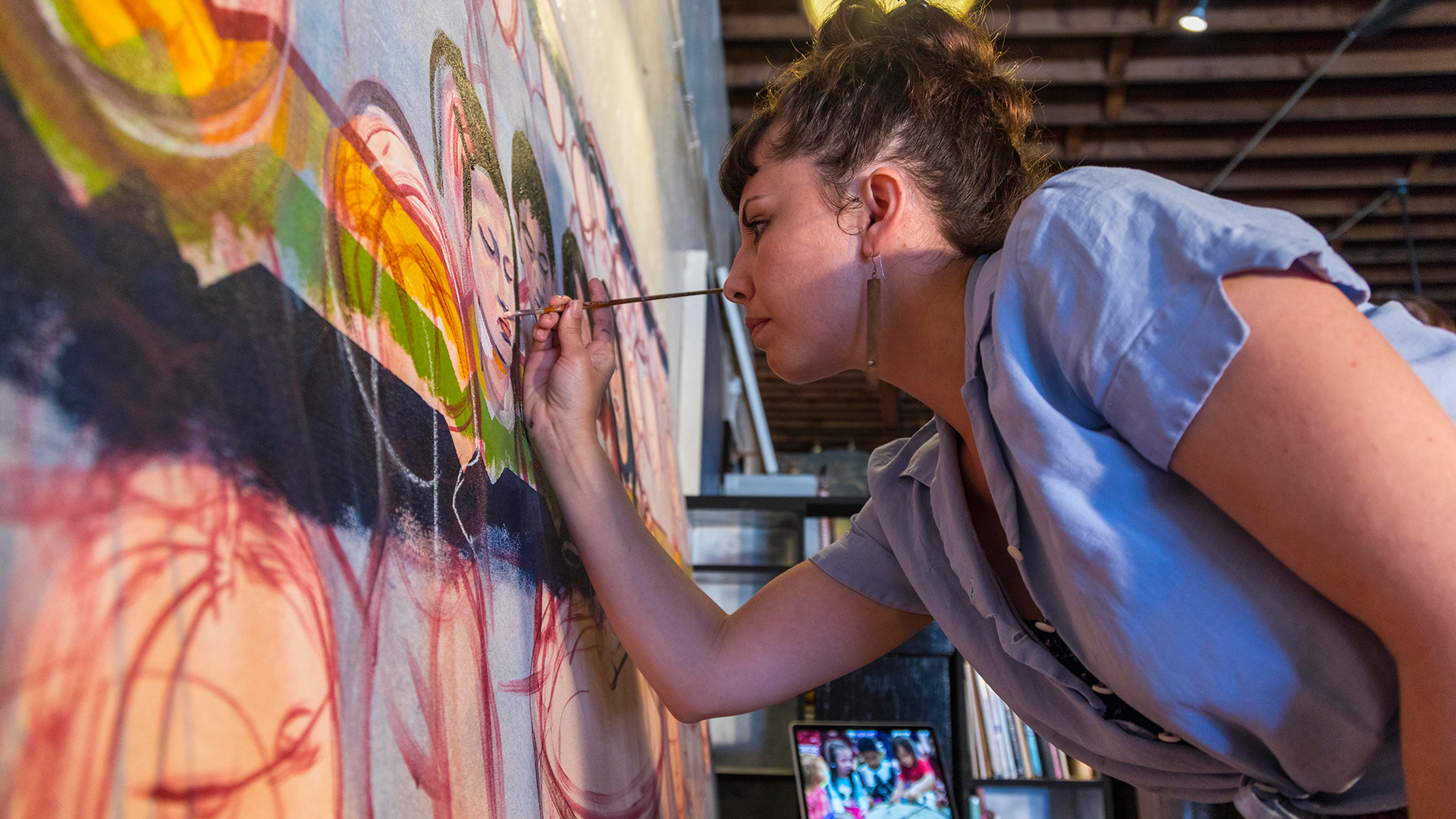 Alex Ponca Stock painting an Osage mural