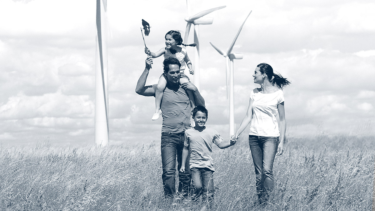 Family strolling through a wind farm