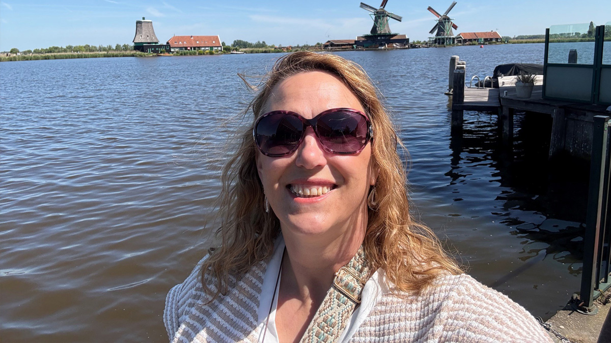 Vicki outside in front of the water
